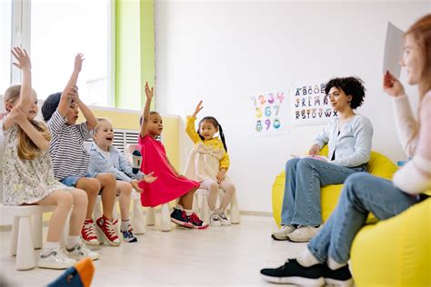 Children Raising Their Hands In A Classroom · Free Stock Photo