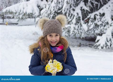 Winter Portrait Of A Smiling Beautiful Little Girl On The Snow Stock