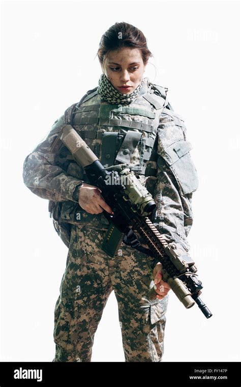 Thoughtful Army Soldier Carrying Rifle Standing Against White