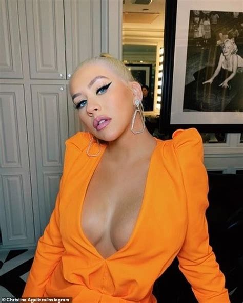 Christina Aguilera Flaunts Major Cleavage In Plunging Orange Jumpsuit In Racy Instagram Post
