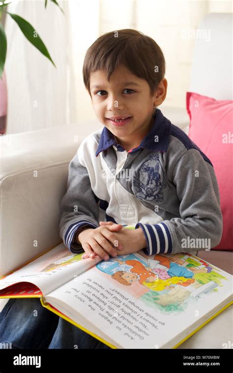 Boy Reading A Book At Home Stock Photo Alamy