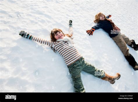 Children Making Snow Angels Stock Photo Alamy