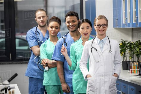 Group Of Medical Workers With Equipment In Laboratory Stock Photo