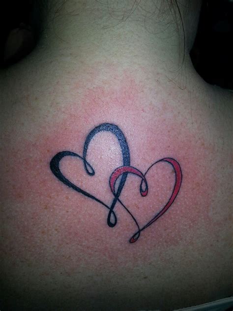 A Womans Back With A Heart And Musical Notes Tattoo On Her Upper Back