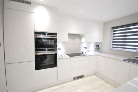 We are renovating out kitchen and just purchased the ikea bodbyn cabinets in white (but they are more of a creamy off white). White gloss j-pull contemporary kitchen with light grey ...