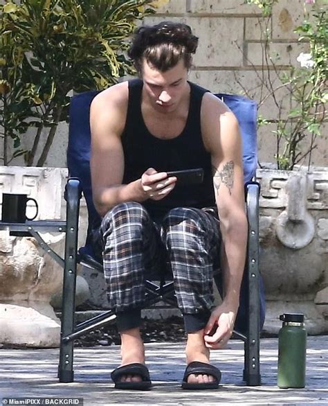 Shawn Mendes Shows Off His Muscles As He Sits Outside In A Tank Top