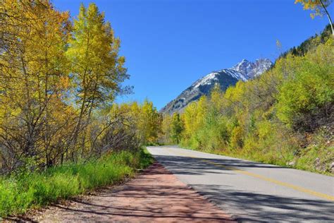 Alpine Road Through The Mountains With Colorful Aspen During Foliage