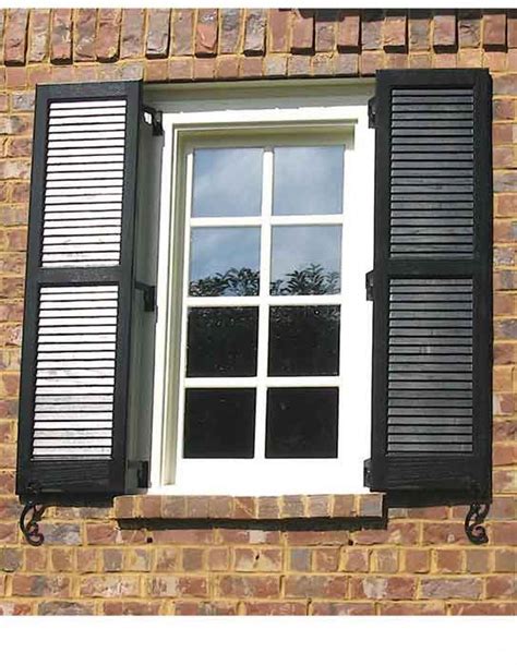 Here Are Some Traditional Black Window Shutters On A Brick House