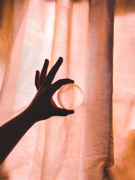 Photo Of Person Holding Crystal Ball · Free Stock Photo
