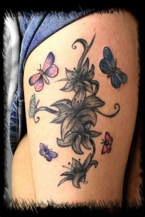 Lilies Butterfly Tattoo Illustrated Beautifully On Her Thigh Lily
