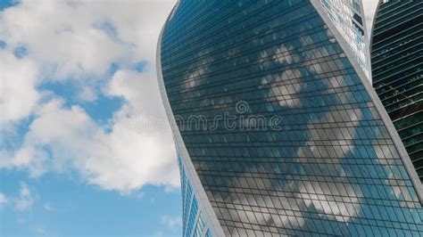 Reflection Of White Clouds In Glass Wall Of Modern Skyscraper Stock