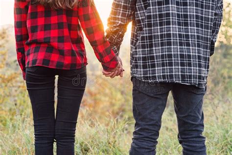 Close Up Young Man And His Girlfriend In Casual Clothes Holds The Hands