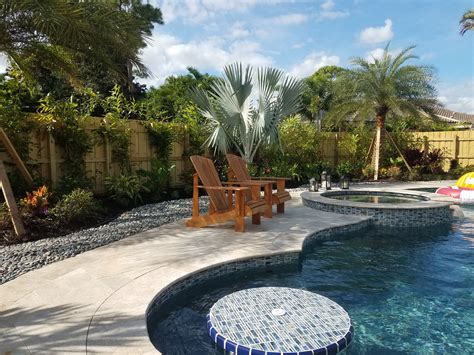 Swimming Pool With Tropical Landscape And Ground Stone
