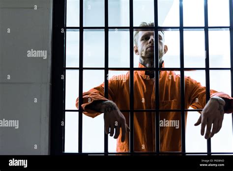 Prisoner Putting Hands Between Prison Bars Stock Photo Alamy