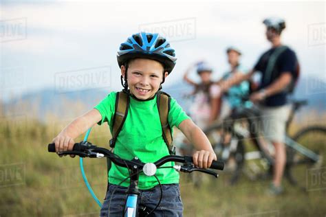 Caucasian Boy Smiling On Mountain Bike Stock Photo Dissolve