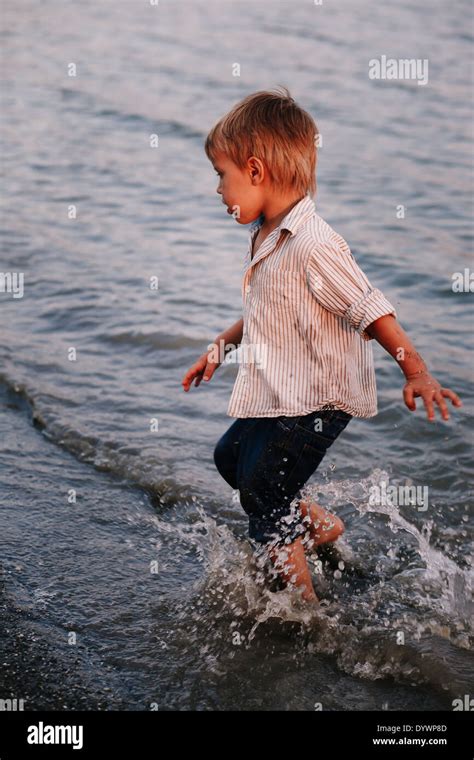 Little Funny Boy Playing In Water Stock Photo Alamy