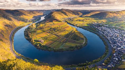Photo about the famous moselle riverbend in bremm, germany seen from the calmont vineyards with a ship on the river. Moselle River, Bremm, Germany - Windows LockScreen