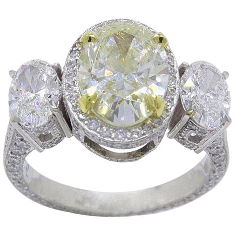 Oval cut diamonds have an elongated shape that maximizes carat weight, and along with their brilliant facets create a bright lively stone. Light Yellow Oval Diamond Three-Stone Engagement Ring 6.44 ...