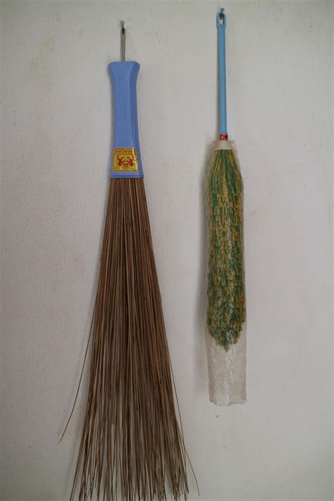 Duster And Broom Stick Hanging On The Wall Of The House 13247130 Stock