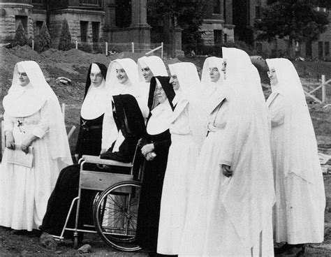 Old Black And White Photograph Of Women In Nun Dresses