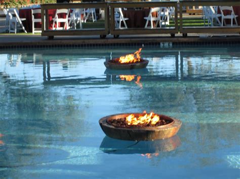 A pool heater that uses a fire pit when there is a fire in the fire pit it heats the water going through the copper pipe. Floating Fire PIt - Encore Creative (With images) | Fire ...