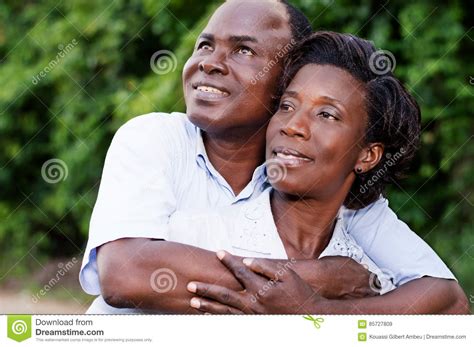 Happy Young Couple Embracing Looking In The Same Direction Stock Image
