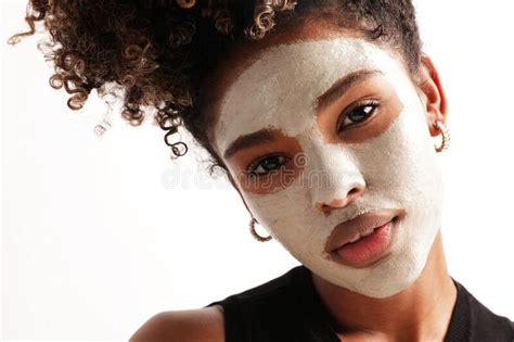 Close Up Of Young Woman Applies Moisturising Face Mask Cares Of Skin