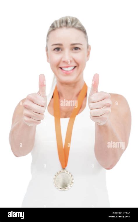 Female Athlete Wearing A Medal And Showing Thumbs Up Stock Photo Alamy