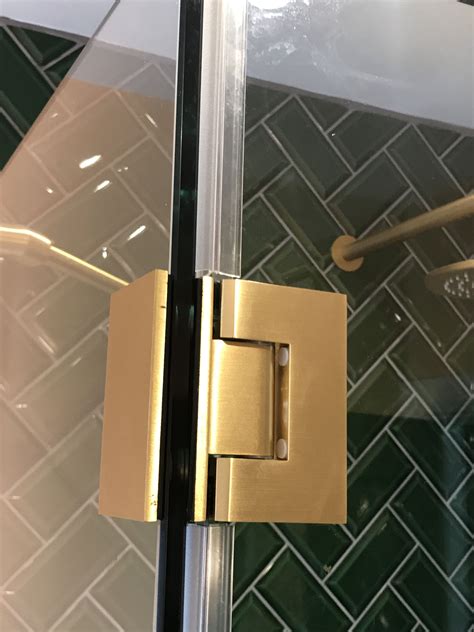 An Open Door With A Handle On The Glass In Front Of A Tiled Wall And Floor