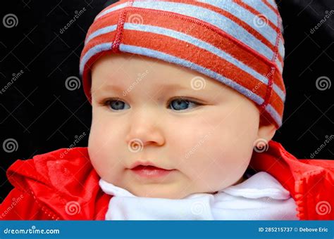 Pretty Portrait Of A Little Girl With Blue Eyes With Her Hat On Her