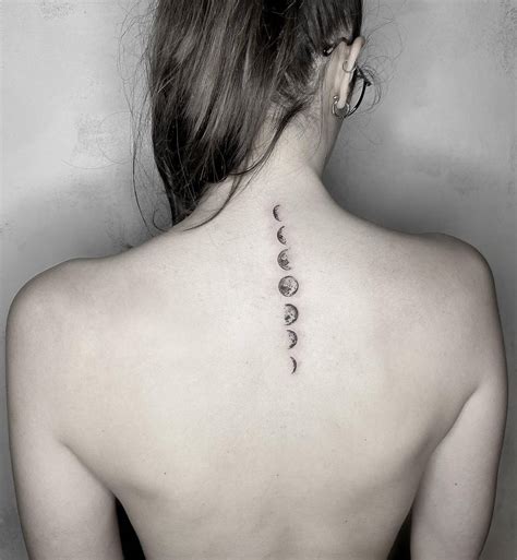 Moon Phases Tattoo Located On The Upper Back