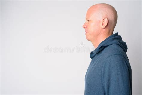 Full Body Shot Profile View Of Mature Handsome Bald Businessman Looking