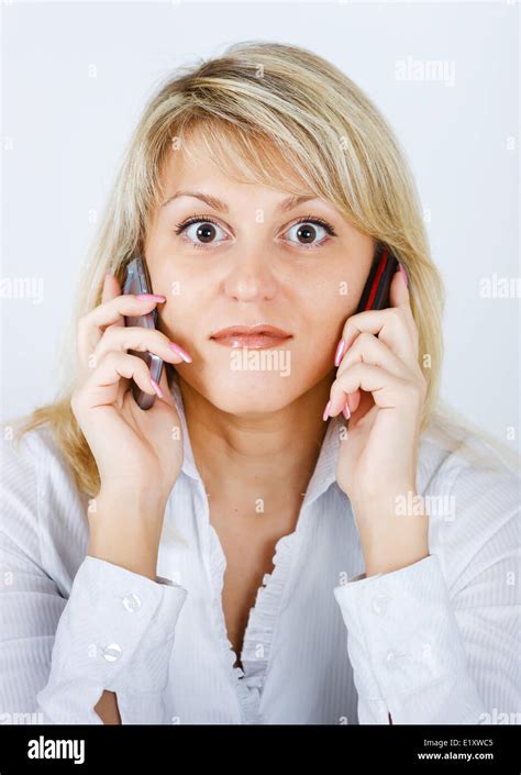 Blonde Girl With Two Mobile Phones Stock Photo Alamy