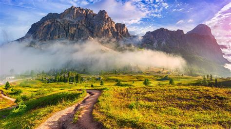 Sand Path Between Green Grass Field Ground Fog Covered Slope Mountains