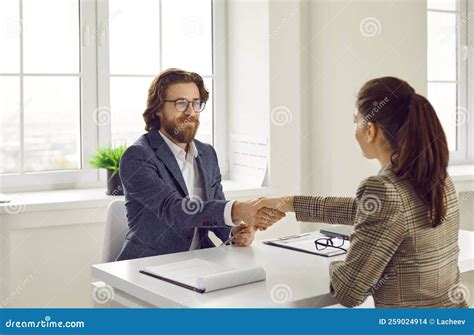 Happy Business Agent And Client Sitting At Office Desk Making Deal