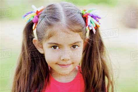 Portrait Of Cute Little Girl With Two Ponytails Outdoors Stock Photo