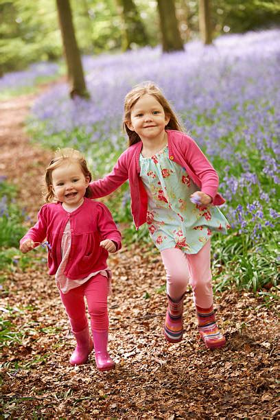 60 Two Sisters Walking On Path Holding Hands Smiling Stock Photos