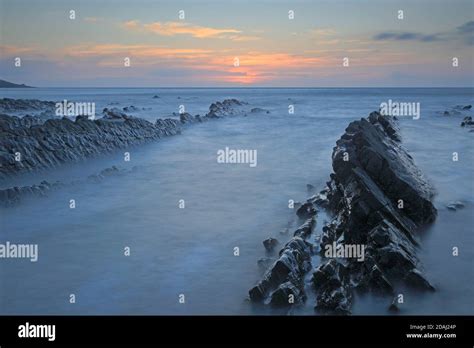 View Of The Rock Ledges At Sunset At Welcombe Mouth Beach On The Devon