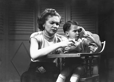 Mother Giving Glass Of Milk To Son 2 3 Sitting In High Chair Bandw Photograph By George Marks