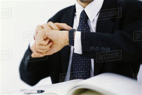 Businessman Checking Time On Wristwatch Cropped Stock Photo Dissolve
