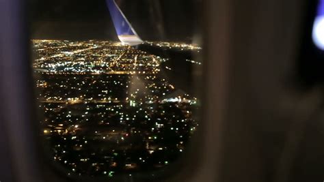 Airplane Window Seat View Of Los Angeles At Night And Wing Of Plane