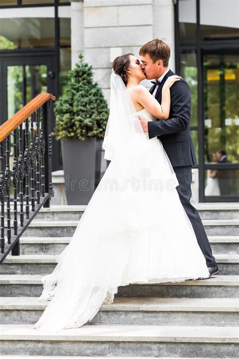 Groom Kissing Bride Outdoors Stock Photo Image Of Floral Outdoors