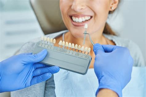Premium Photo Male Dentist And Woman In Dental Clinic Choosing