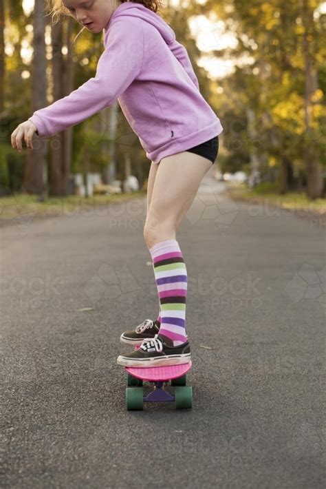 image of girl skateboarding in a street austockphoto