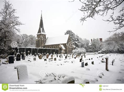 Snow Covered Church And Grave Yard Royalty Free Stock Photography