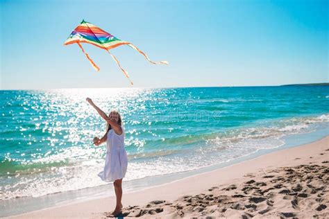 Little Girl Flying A Kite On Beach At Sunset Stock Image Image Of