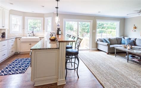 Our products our top of the line and are built to last! This kitchen features white cabinets with a mocha glaze, glass front cabinets flanking the range ...