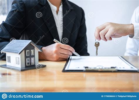Helping you secure your future. Home Insurance And Real Estate Investment Concept, Sale Agent Giving House Key To New Client ...