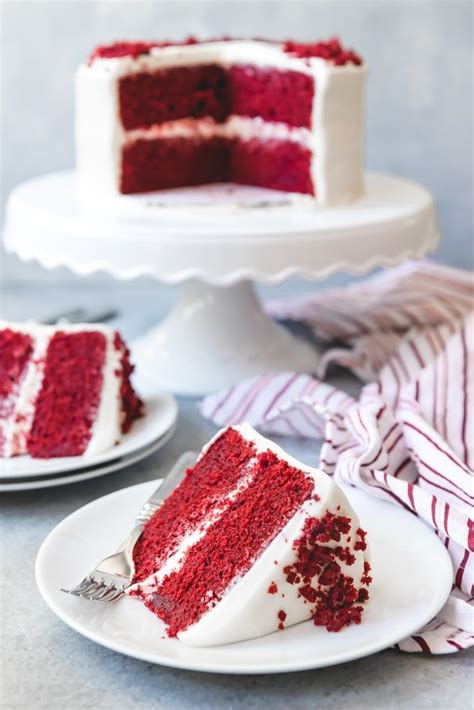 Here how the cake ended up that color. An image of a slice of red velvet cake with cream cheese frosting on a plate with the sliced red ...