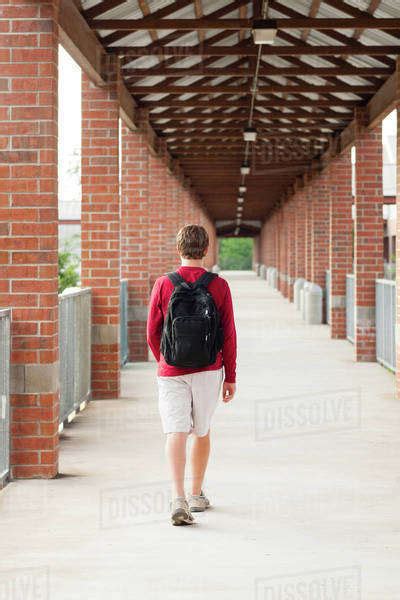 Caucasian Teenage Boy Walking On School Campus Stock Photo Dissolve